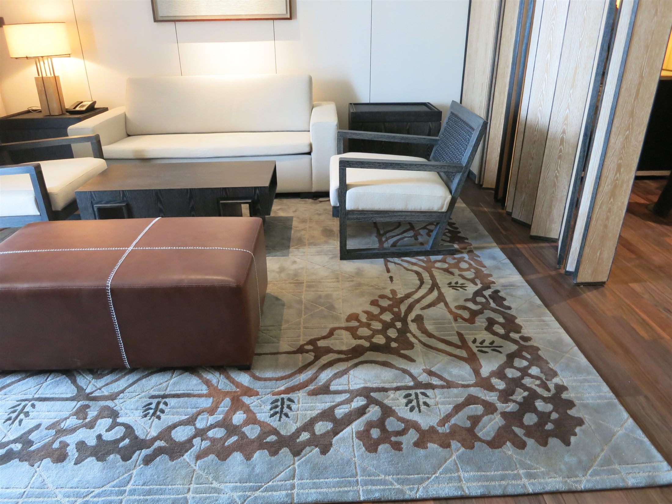 Custom rug with coral-like linework in a hotel suite